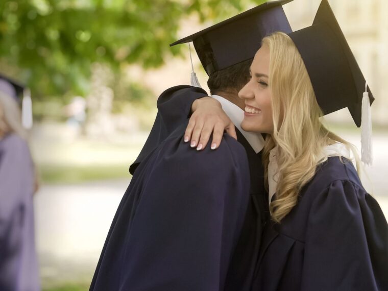 Man and woman hugging after graduation