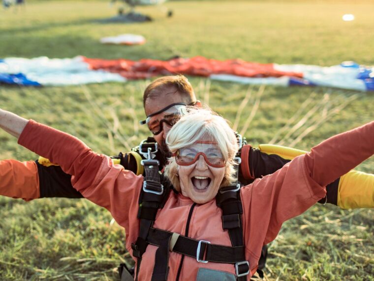 Woman cheering after landing a sky dive