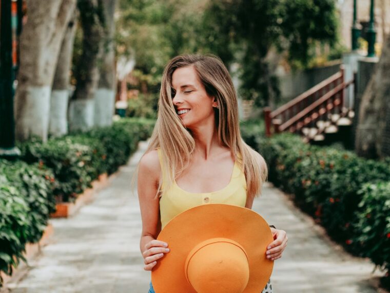 Girl holding orange hat