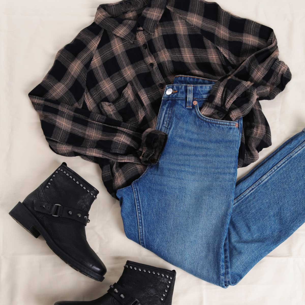 Flannel style outfit laid on ground