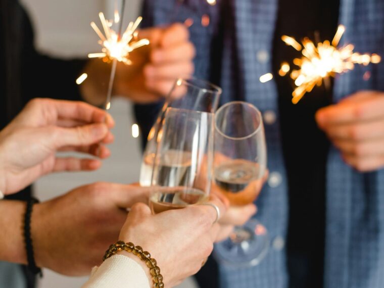 People holding sparklers and champagne glasses