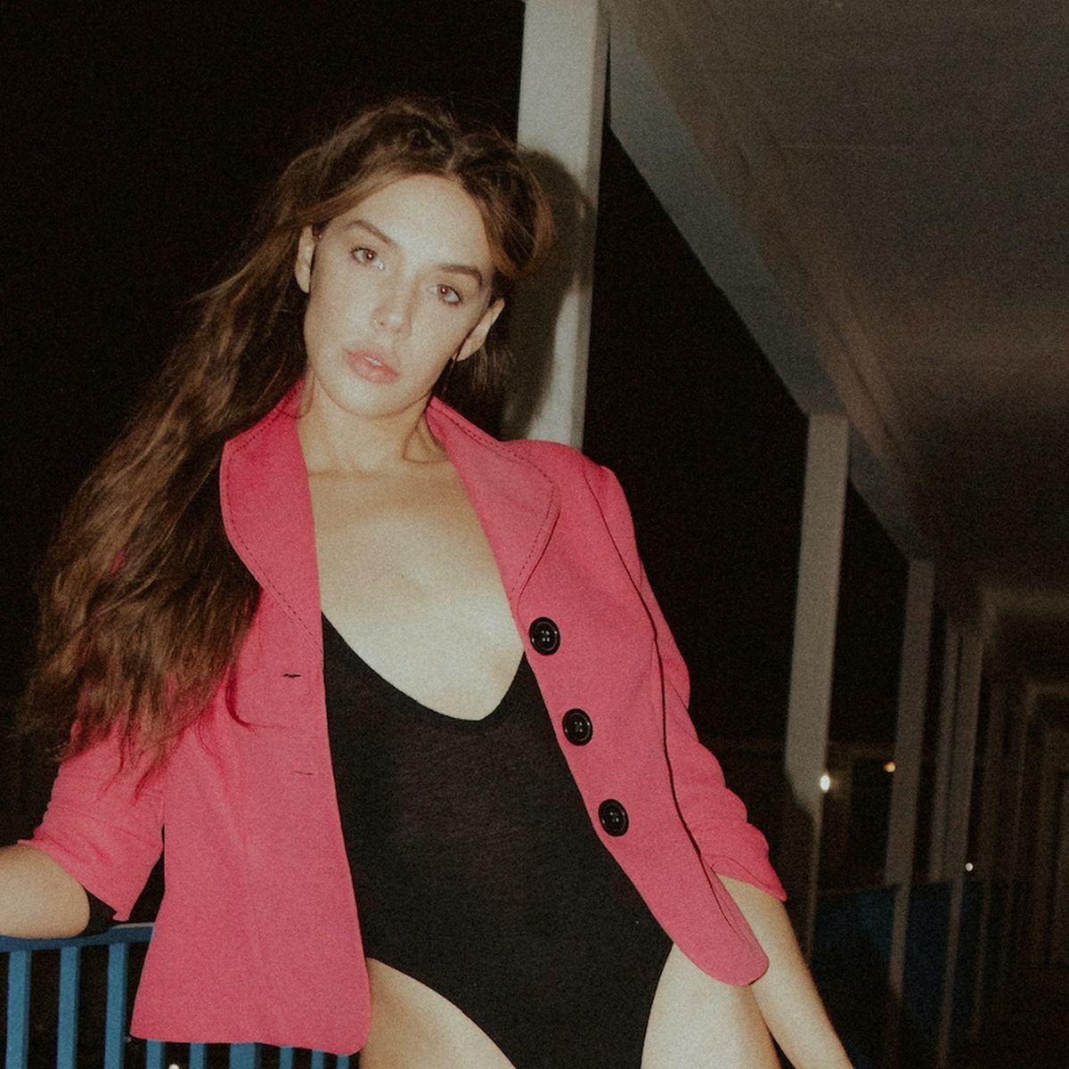 Girl in leotard and red blazer, showcasing circus inspired outfits as streetwear.