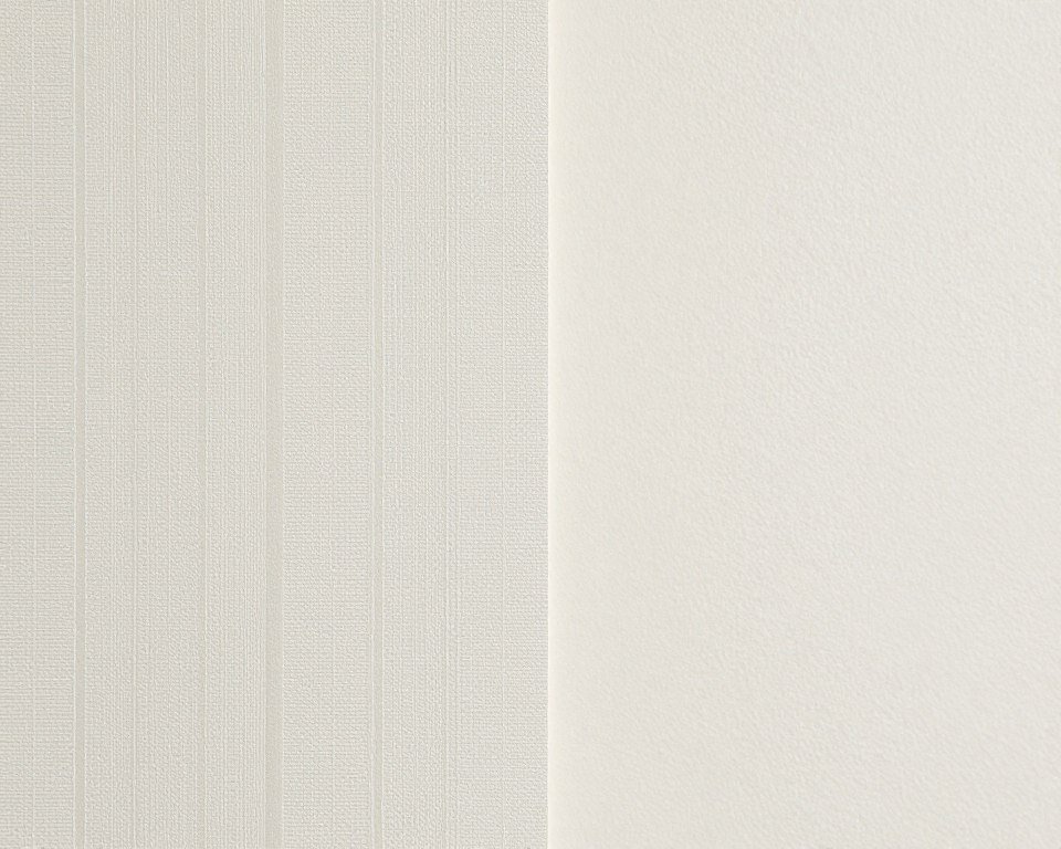 Close-up of clean division line between wallpaper and paint