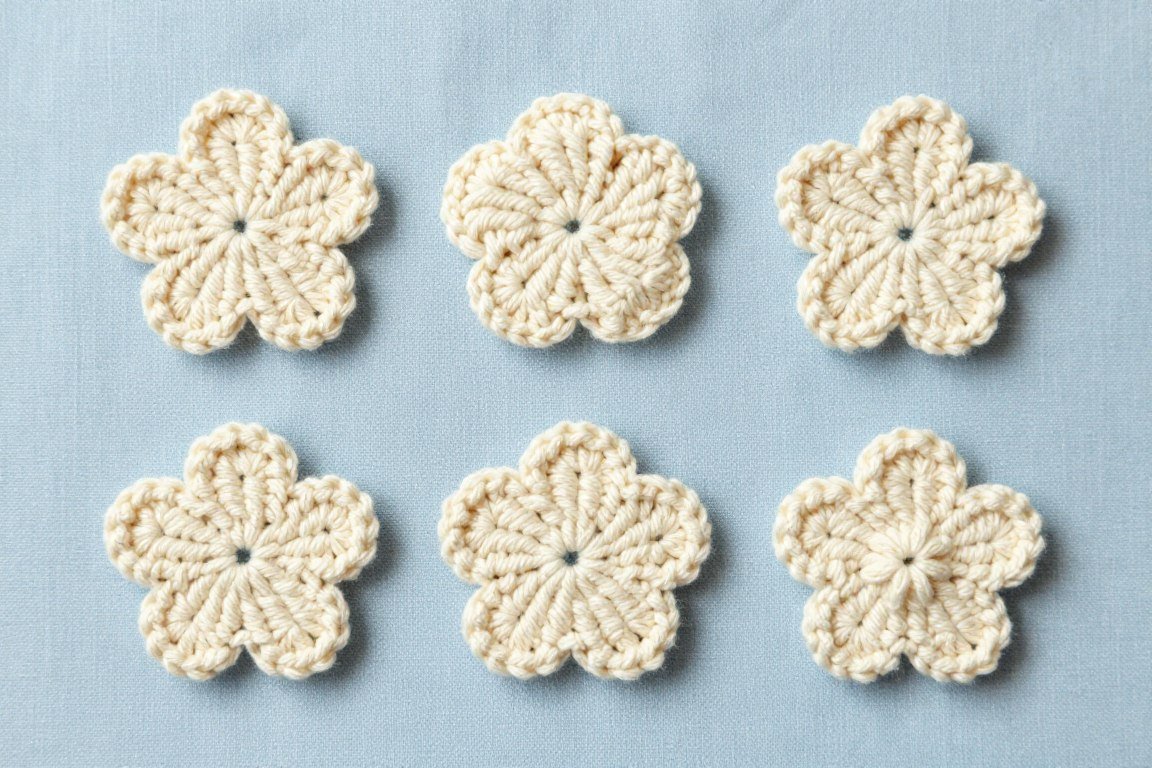Collection of simple single-color crochet flowers showing variety possible with basic techniques