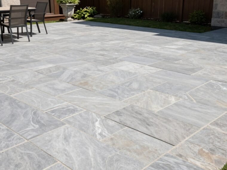 Elegant ashlar slate stamped concrete patio with light gray tones and natural stone appearance