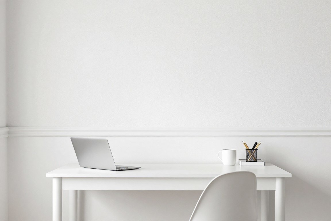 Minimalist home office with textured wallpaper and white paint