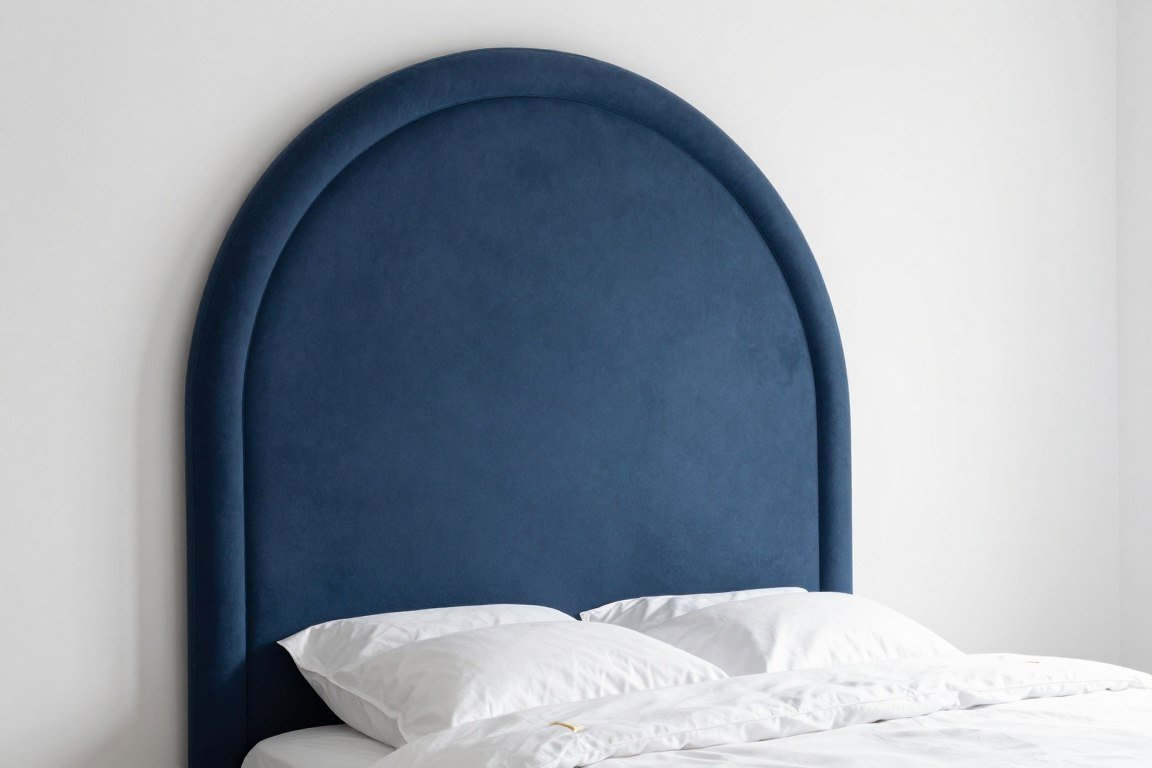 Modern painted wall headboard in deep navy blue with geometric arch shape behind white bed