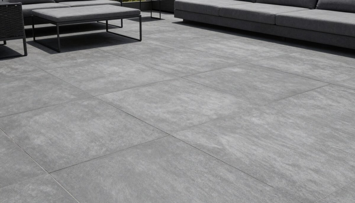 Modern scored concrete patio with geometric grid lines in charcoal gray