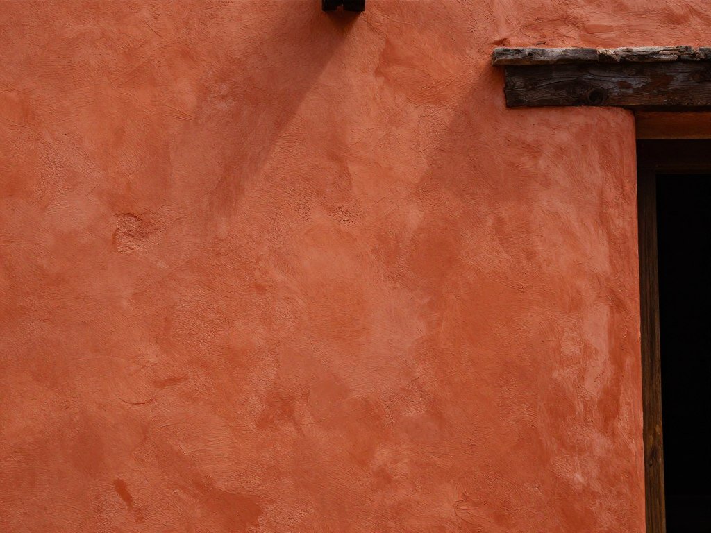 Terracotta painted walls in Mexican home decor style with natural light