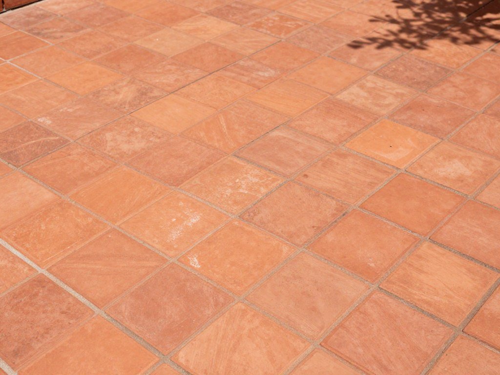 Terracotta tile patio floor with traditional Mexican patterns