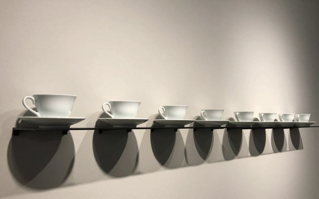 tea cups arranged by size from large to small creating visual rhythm