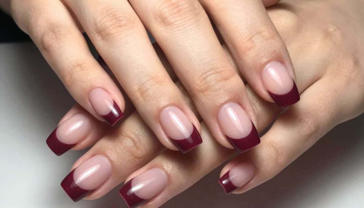 Burgundy French tip manicure on natural nail bed showcasing classic fall nail art