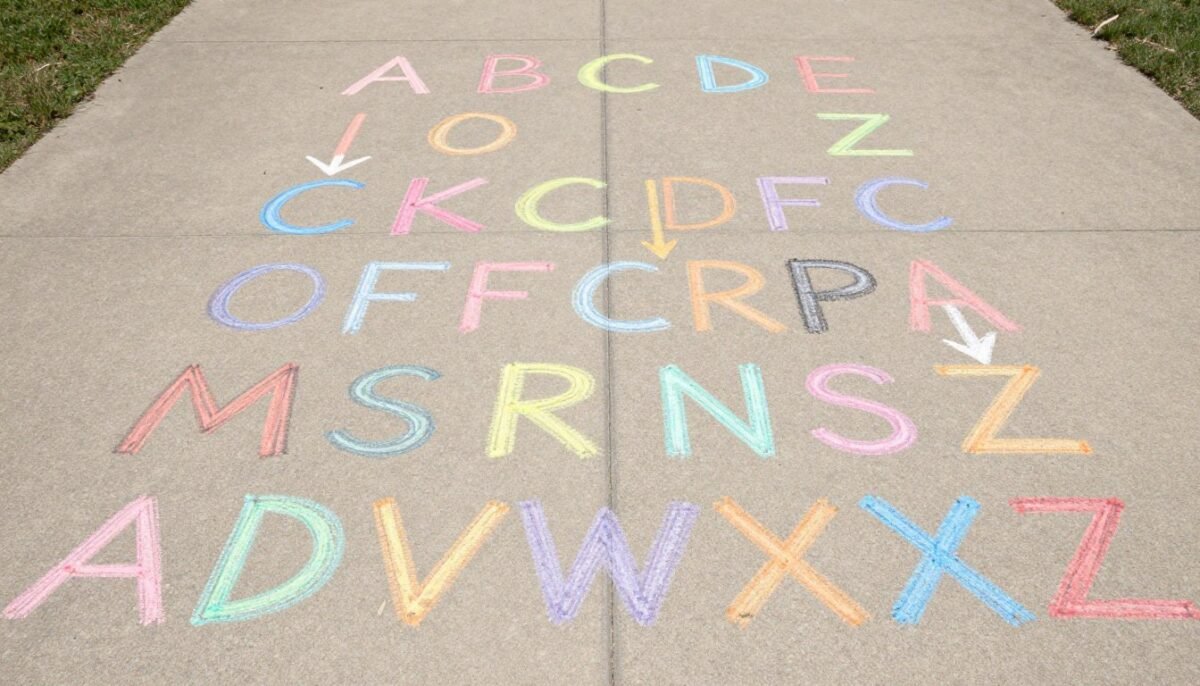 Large colorful alphabet letters drawn in chalk with arrows showing path direction Large colorful alphabet letters drawn in chalk with arrows showing path direction