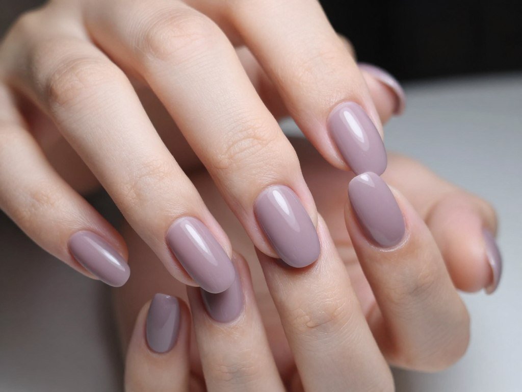 Mauve French tips on almond nails with purple-grey muted tone