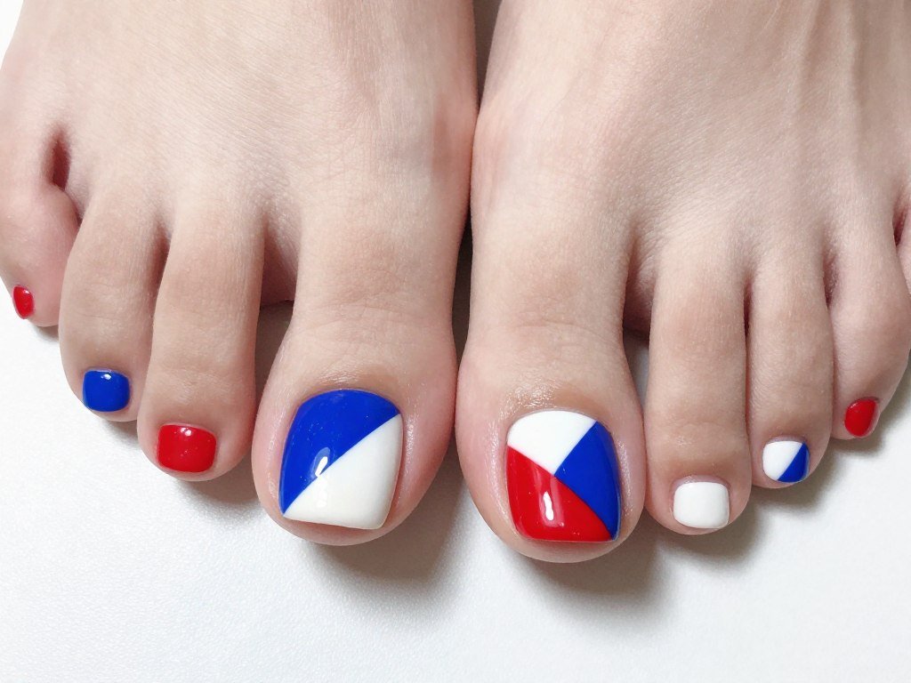 Modern geometric color blocking on toe nails with red white and blue panels