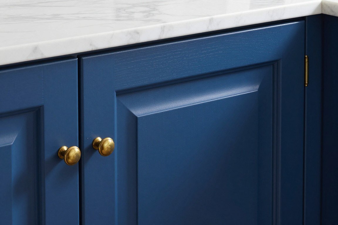 Royal blue cabinet detail with white marble and gold hardware