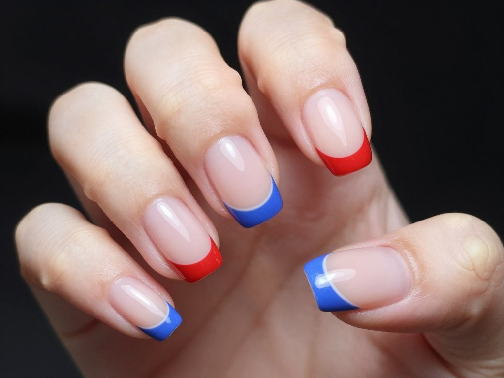 Short nails with patriotic French tip manicure in red and blue