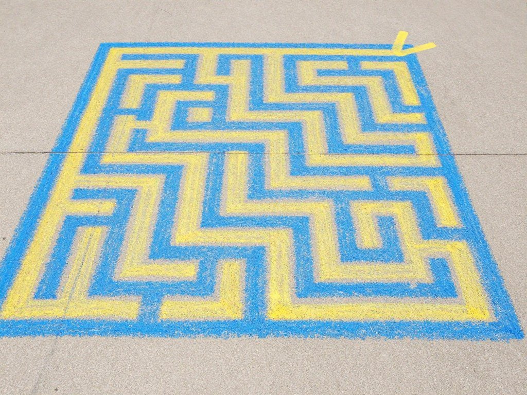 Simple maze pattern drawn in chalk with start and finish points