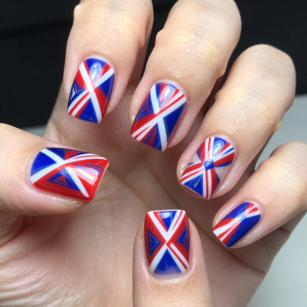 Square nails featuring diagonal red and white stripes with blue accent triangles