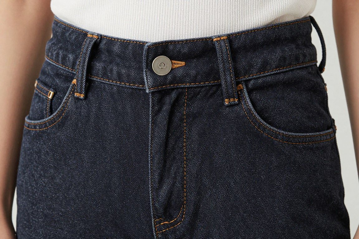 close-up of high-waisted jeans showing proper waist placement