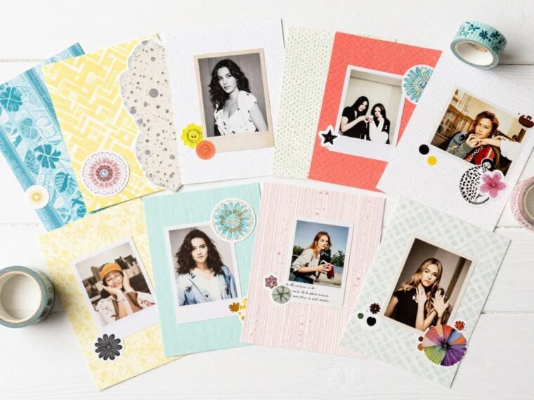 colorful scrapbook materials spread on a table with photos and embellishments