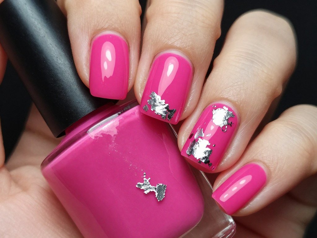 Bright fuchsia pink nails with silver foil accent pieces
