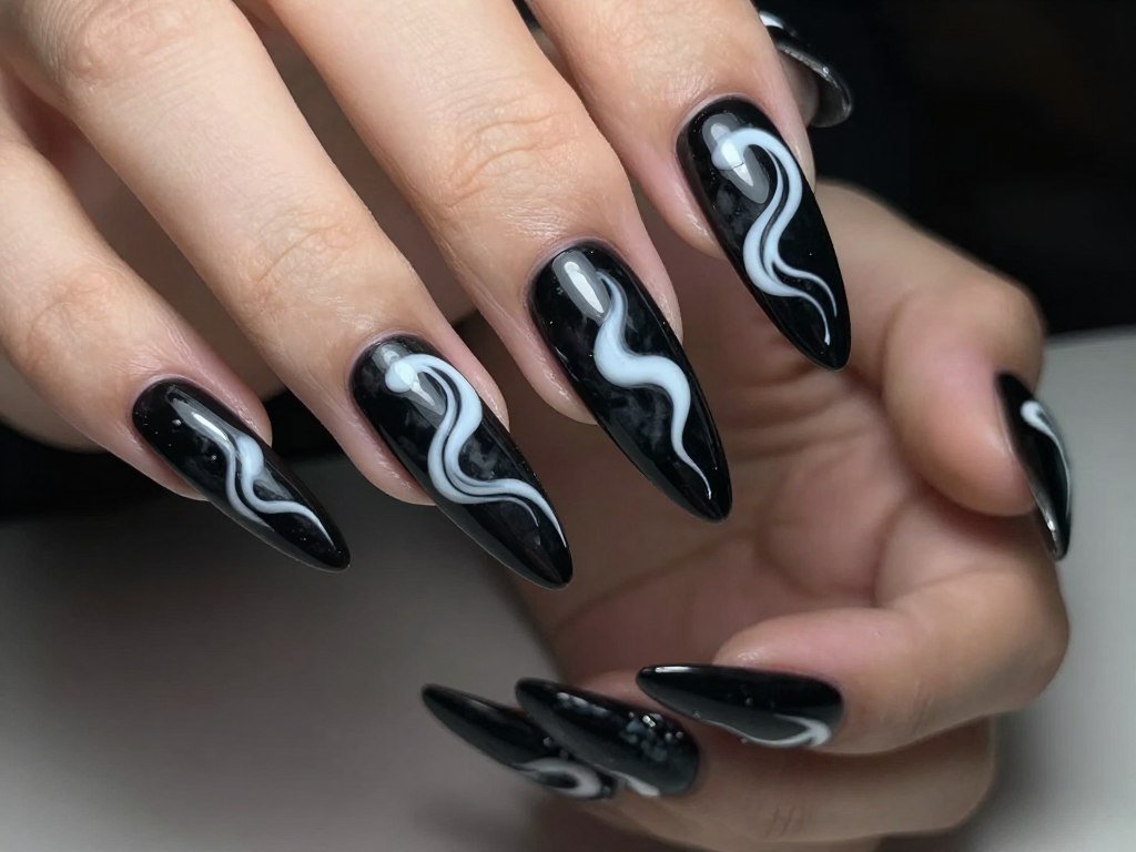 White swirl patterns on black nail polish base