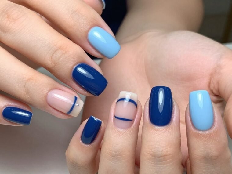 blue summer nail designs featuring light blue and navy manicures on short nails