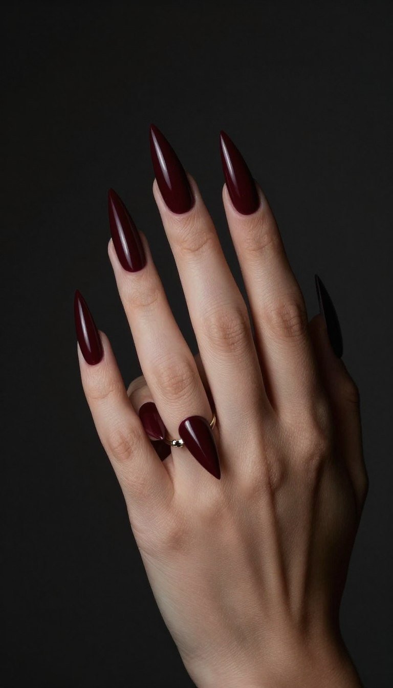 long burgundy stiletto nails with pointed tips